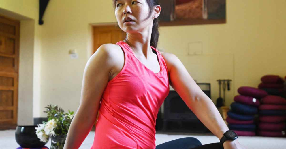 BIPOC retreatant does yoga in the South Wing Annexe at The Sharpham Trust