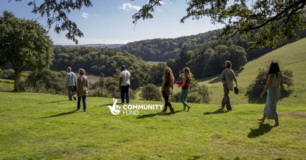 MIN walking in landscape with NLCF logo
