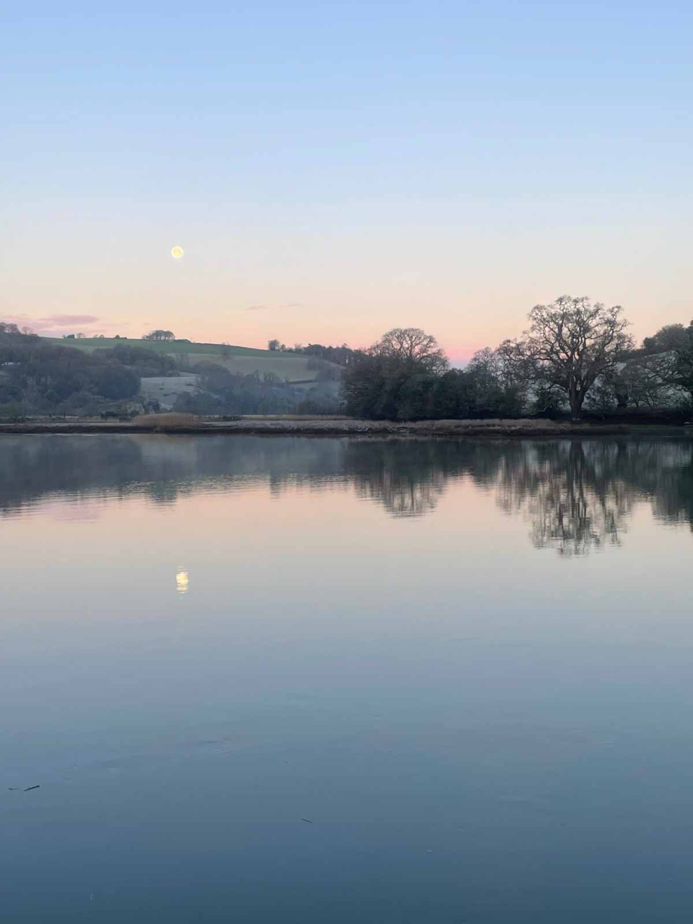 Moon reflections: The serenity of the River Dart in the morning