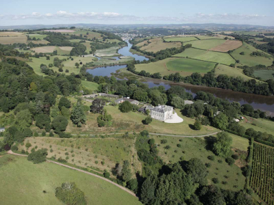 Sharpham House and orchards in the River Dart Valley, with Totnes in the background