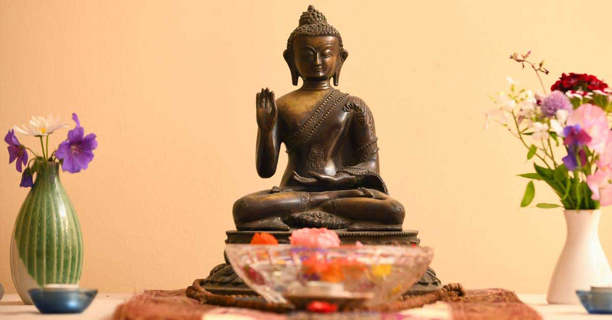 Buddha on the altar at The Barn retreat centre at Sharpham