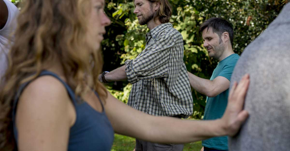 People in a circle, touching