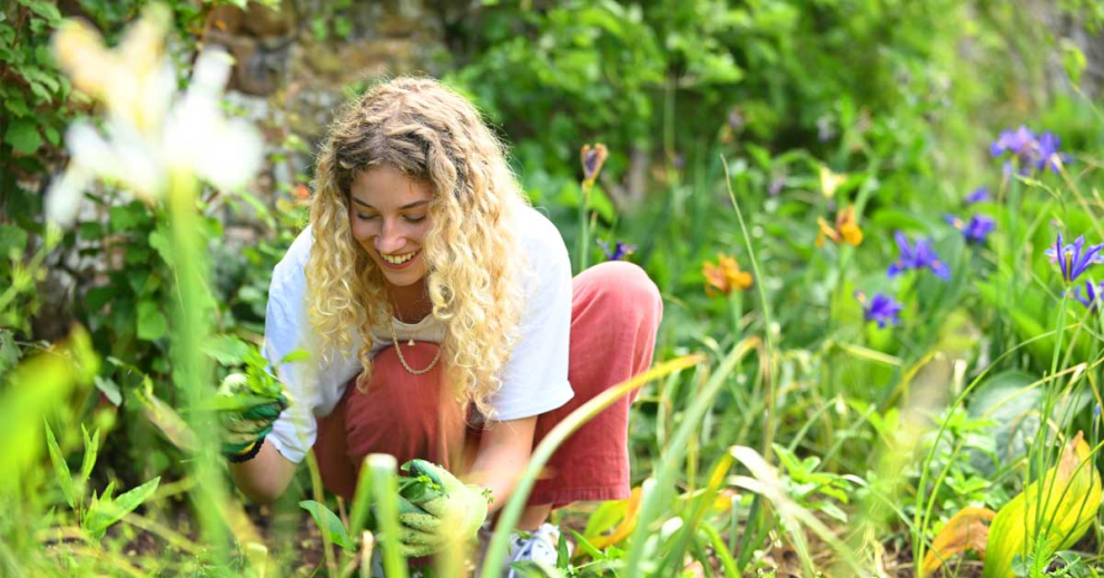 A retreatant spends mindful time in the Walled Garden on a Coach House retreat