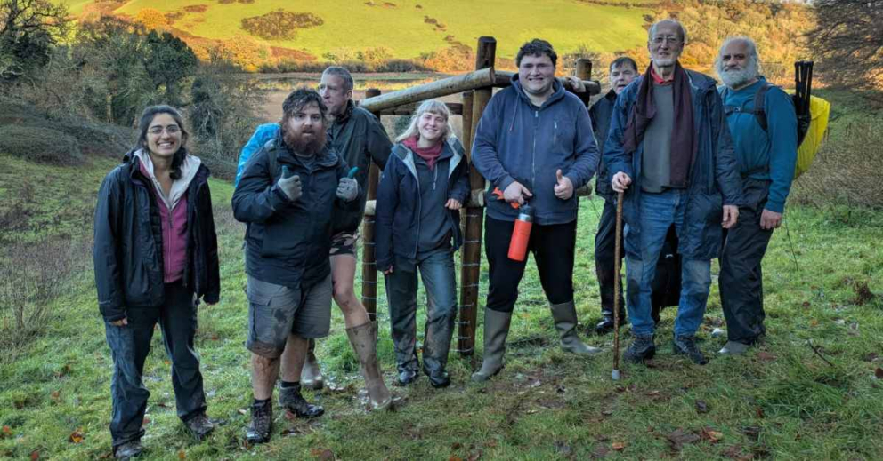 Volunteers and Ambios leaders working to install tree guards and plant trees as part of the Plymouth and South Devon Community Forest project