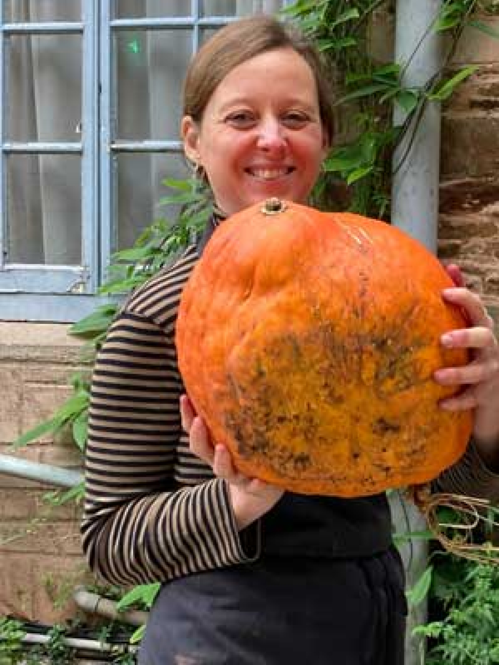 Cook Sybille shows off a wonderful squash grown at The Sharpham Trust mindfulness & meditation centre