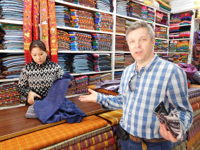 Sharpham Trust Director Julian Carnell attempting to buy local cloth in Bhutan