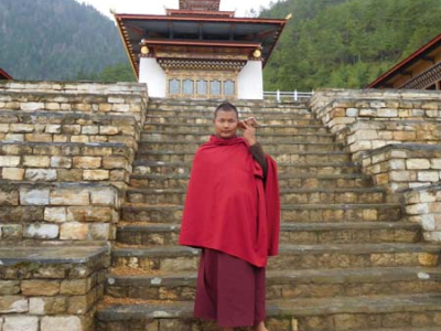 Bhutan monk listening to music on his phone - witnessed by Sharpham Trust Director Julian Carnell on his visit to Bhutan