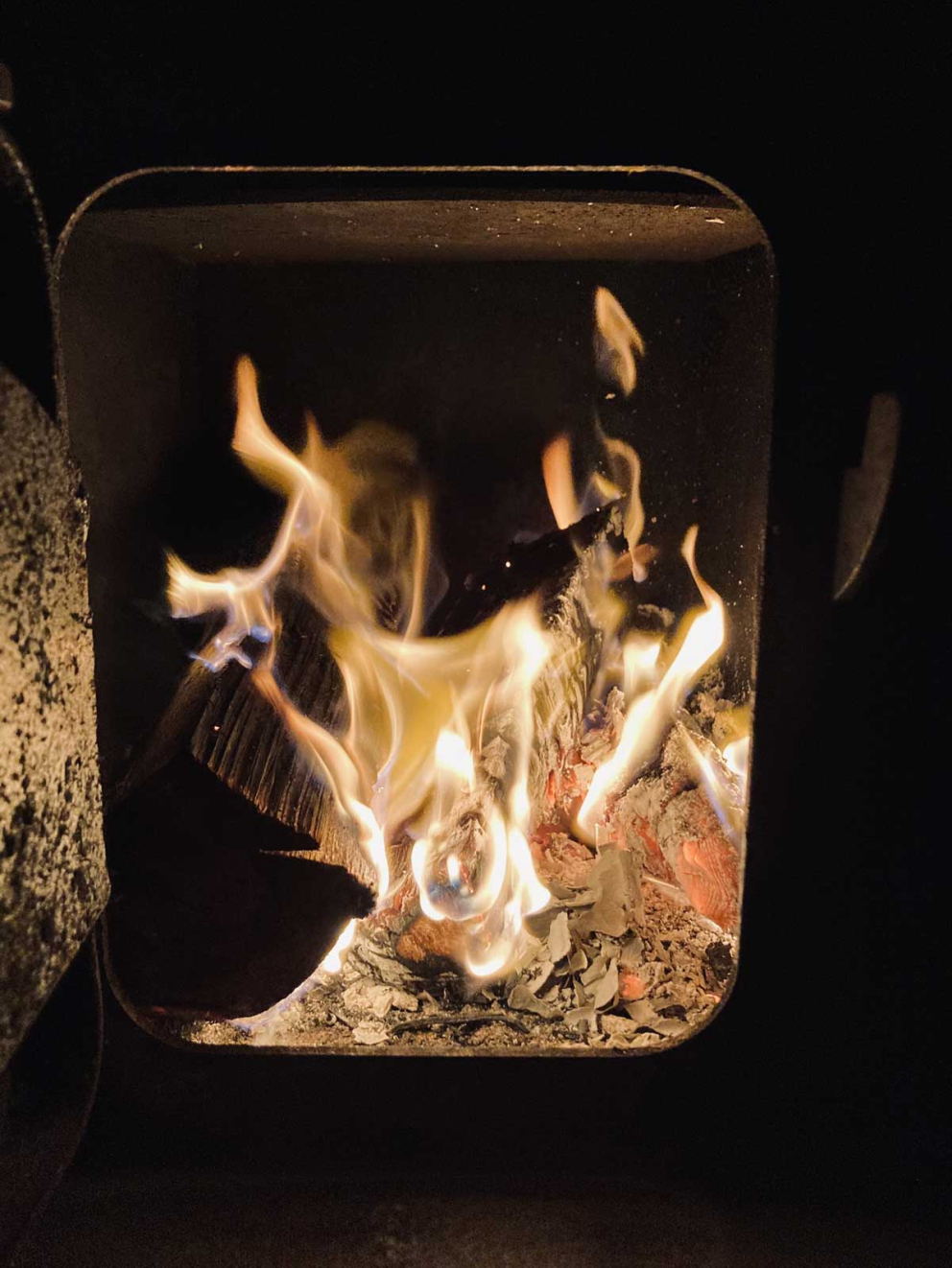 The woodburner in The Goose House at The Barn at The Sharpham Trust meditation retreat centre